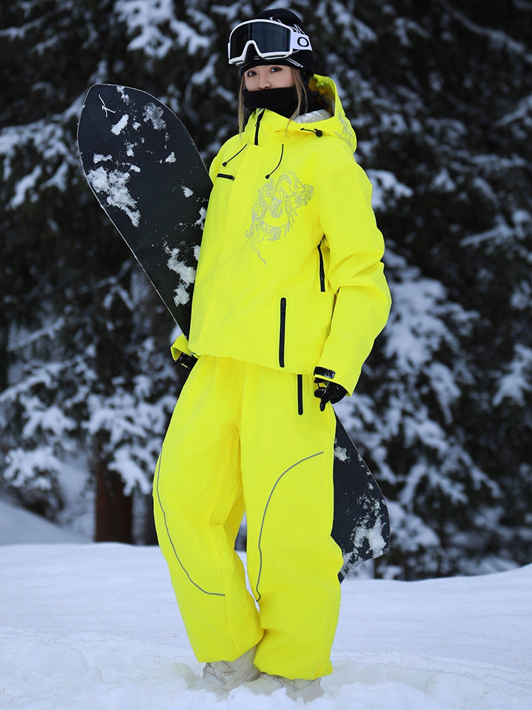 Model wearing the yellow baggy ski jacket and pants set in the snow