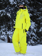 Model wearing the yellow baggy ski jacket and pants set in the snow