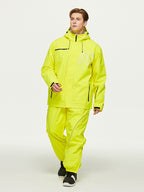 Model walking in the yellow insulated ski jacket and pants set