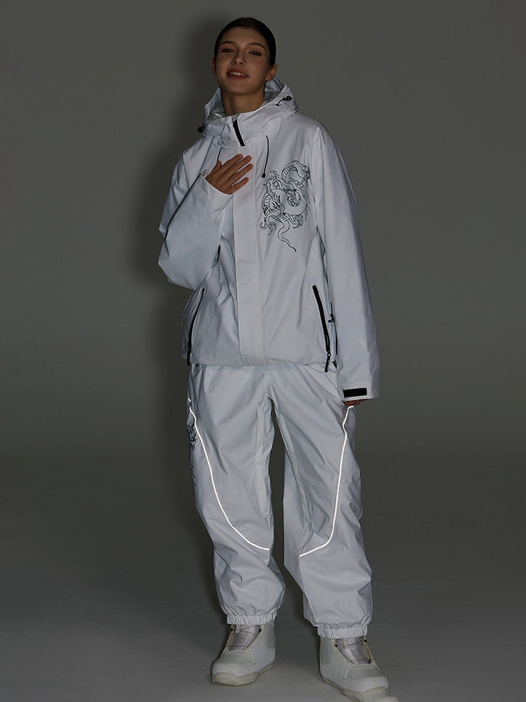 White ski jacket and pants set photographed in low light