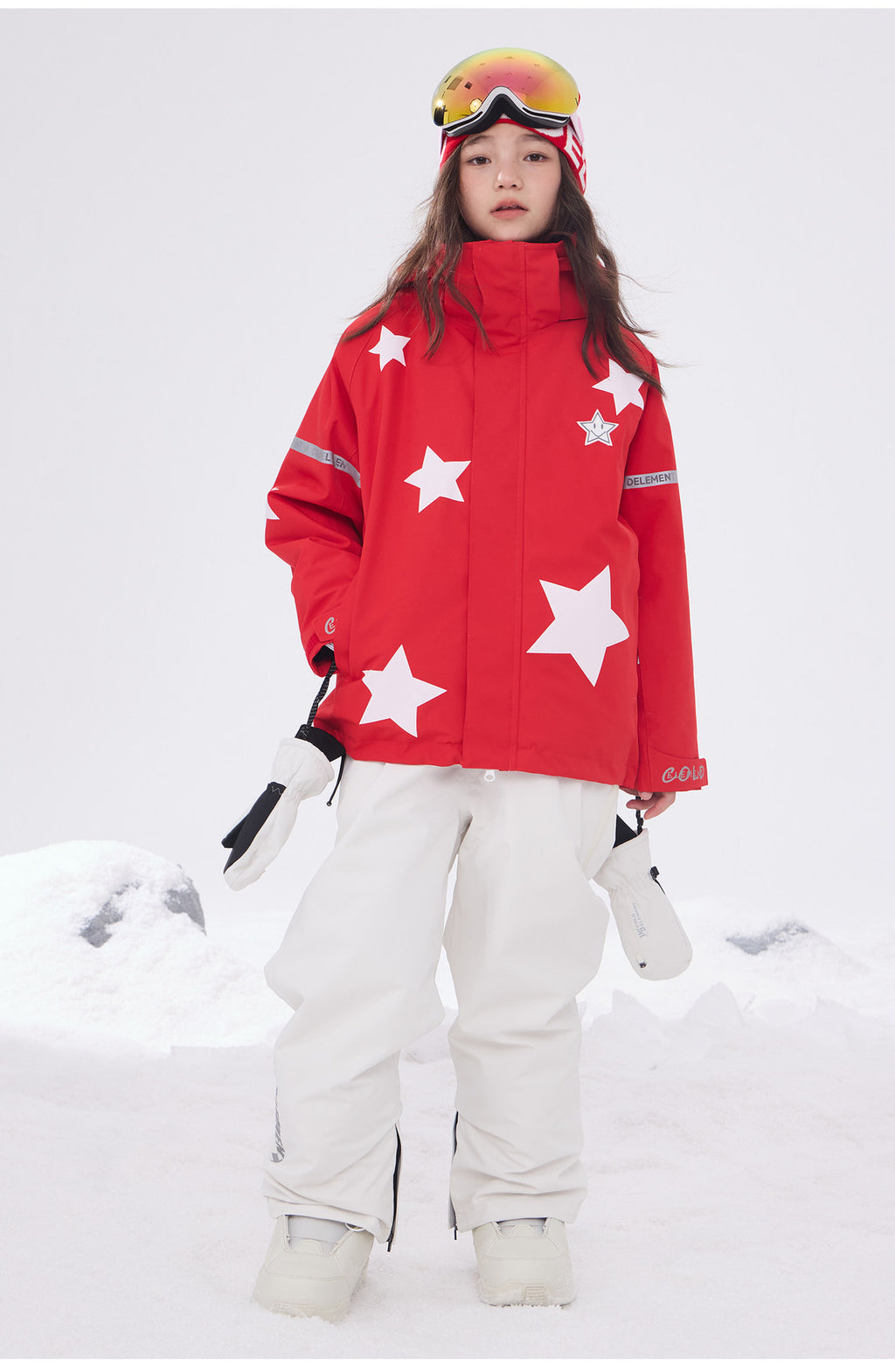 Red kids snowboard jacket with white star print in the snow