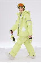 Kid in lime green star print ski jacket walking in the snow