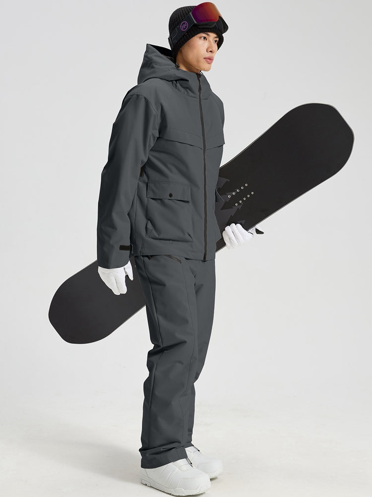 Men's dark grey snowboard jacket and pants set holding a snowboard
