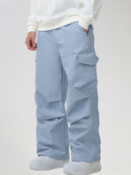 Men's Baggy Cargo Pocket Ski Pants in Light Blue - Three-Quarter View with Hand in Pocket