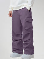 Men's Baggy Cargo Pocket Ski Pants in Purple - Three-Quarter View with Hand in Pocket