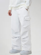 Men's Baggy Cargo Pocket Ski Pants in White - Three-Quarter View with Hand in Pocket