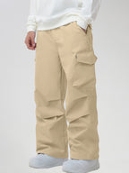 Men's Baggy Cargo Pocket Ski Pants in Khaki - Three-Quarter View with Hand in Pocket