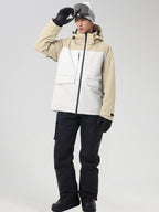 Men's khaki and white color-block ski jacket with black snow pants, front view