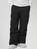 Men's Baggy Cargo Pocket Ski Pants in Black - Front View with Hands in Pockets