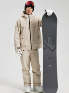 Men's khaki snowboard jacket and pants set holding a snowboard, front view