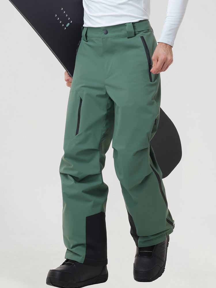 Men's insulated ski pants in Green worn with a snowboard