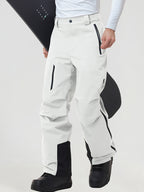 Men's insulated ski pants in White worn with a snowboard