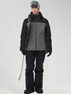Men's grey and black color-block ski jacket with matching black pants, holding ski poles