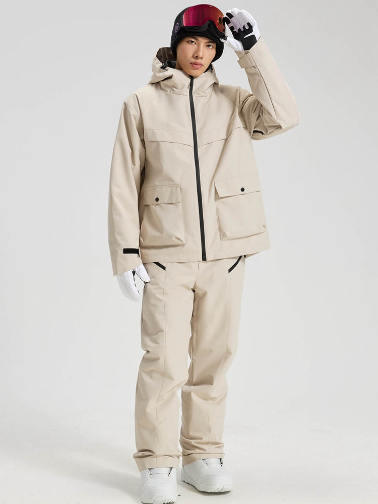 Men's khaki ski jacket and pants set with hand raised to the hood