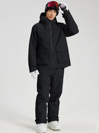 Men's black snowboard jacket and pants set with hand raised to the hood