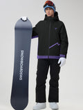 Front view of the men's casual ski jacket and snow pants set in black, holding a snowboard