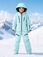 Kids pink ski jacket and pants set in snow
