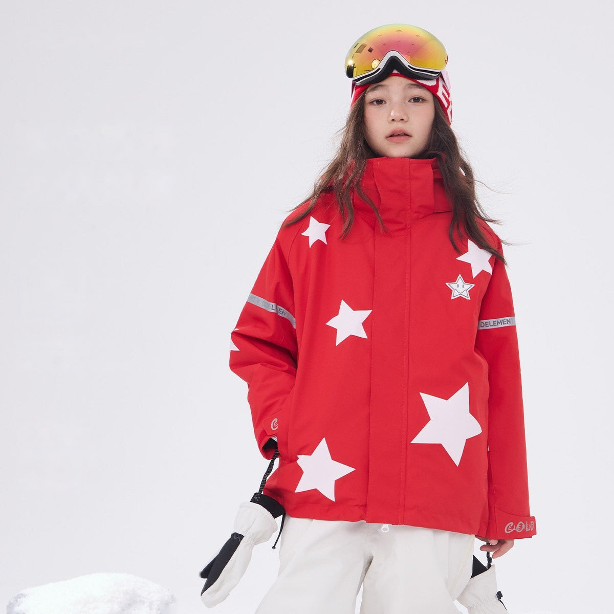 Kids' red star print 3L ski jacket worn by a child in the snow