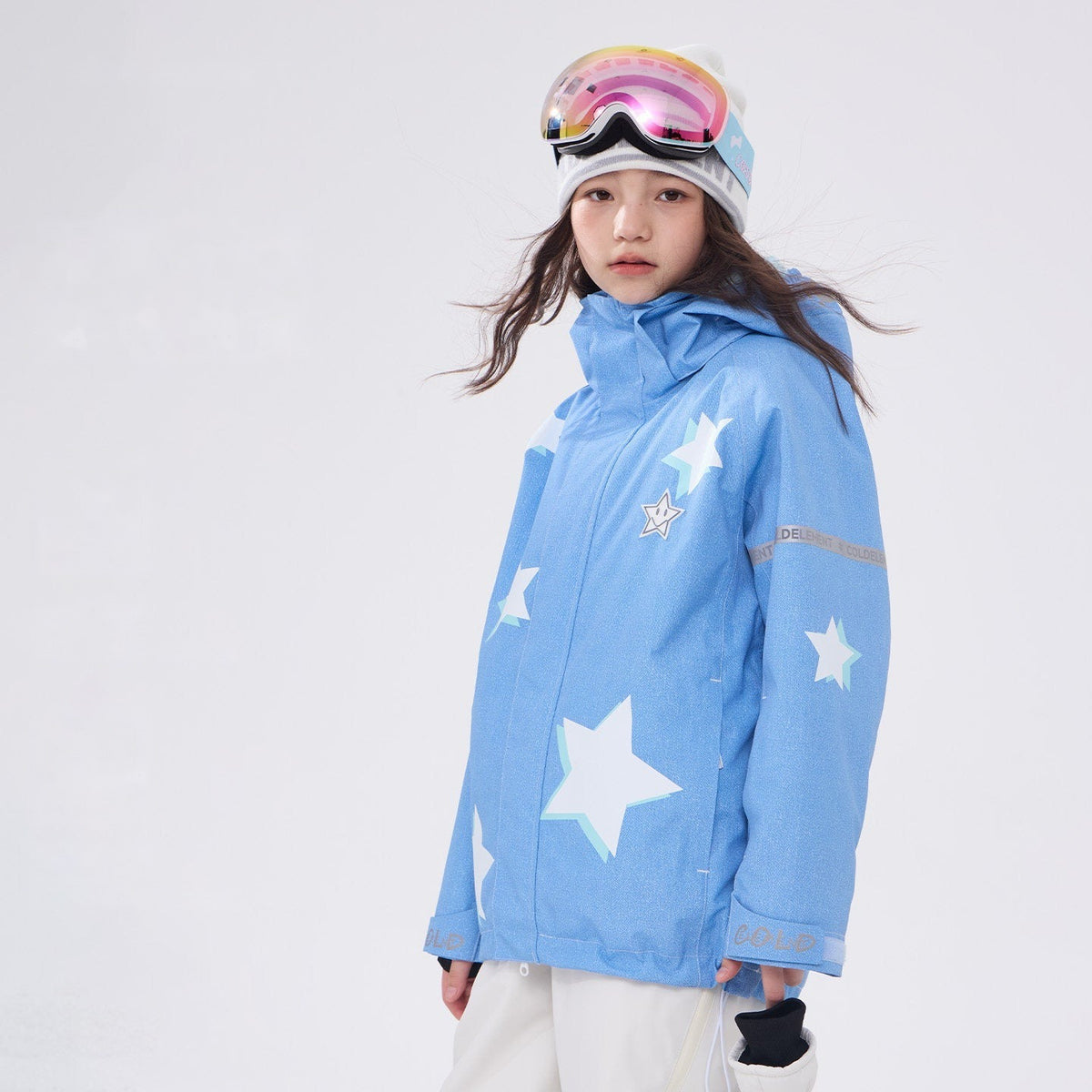 Girl in light blue waterproof snow jacket showing 3L shell
